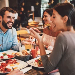Three people sharing a meal out